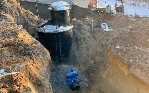 A black well connected to the new water main and partially covered by ground | Pipelife