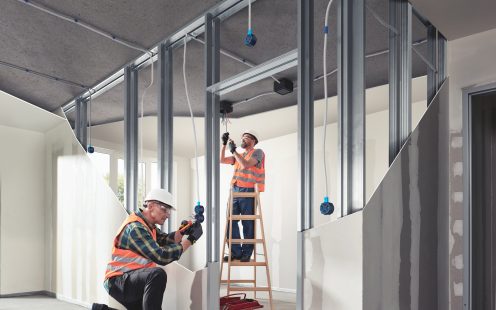 Two electricians installing electrical system  