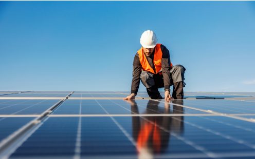 Electrical Installer on the Roof Installating Solar Panels